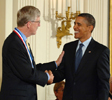 President Barack Obama and NIH Director Francis Collins shaking hands.