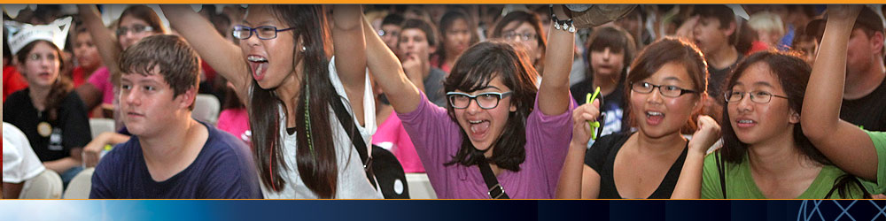 Photo of a group of middle school students cheering..