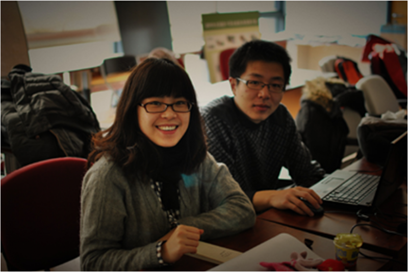 Photo of two students working together at a computer. 