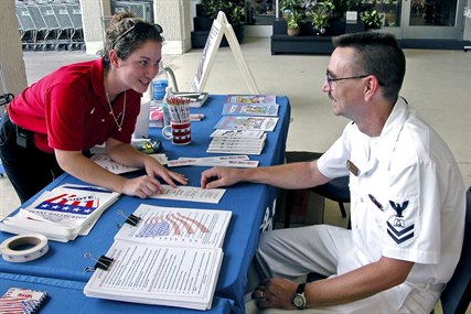 File photo: Navy Petty Officer 2nd Class Scotty Wells, assigned to Naval Air Station Jacksonville, Fla.,listens to St. Johns County Assistant Supervisor of Elections, Aimee Brennan, explain  the registration procedure in preparation for staffing a voter’s registration booth during a three-day event on base, Sept. 23, 2004. 