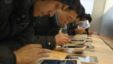 Customers test out Apple iPads in an Apple Store in downtown Shanghai, February 29, 2012.