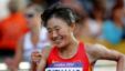 Choeyang Kyi celebrates her third place finish in the women's 20-kilometer race walk at the 2012 Summer Olympics, Saturday, Aug. 11, 2012, in London.  (AP Photo/Emilio Morenatti)