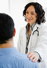 Hispanic doctor talking to patient in doctor's office.