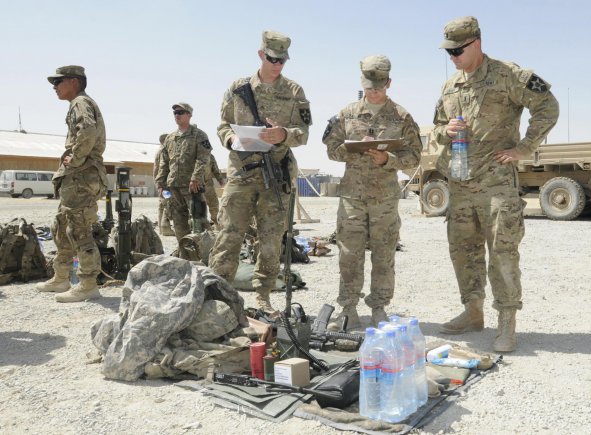 From left, Staff Sgt. Joshua Rinier, Capt. Lawrence Csaszar and 1st Lt. Adam Losey, members of Alpha Company, 5th Battalion, 20th Infantry Regiment, conduct inspections at Forward Operating Base Spin Boldak prior to an air assault mission during Operation Southern Strike III in the district of Spin Boldak, Kandahar province, Afghanistan, Aug. 31, 2012.