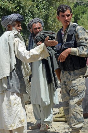 A member of the 3rd Zone Afghan Border Police meets with local villagers during Operation Southern Strike III in the village of Enjergay, Spin Boldak district, Kandahar province, Afghanistan, Sept. 3, 2012. The operation focused on dislocating the enemy from the local populations and connecting the district leadership with outlying villages.