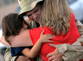 Deployed Service Member Hugging Daughters
