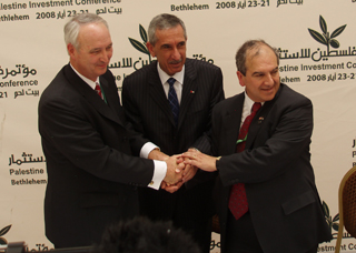 (Left to Right) USTDA Director Larry W. Walther, His Excellency Kamal Hassouneh, and BCI Managing Director Said Baransi shake hands following the signing of a USTDA grant agreement that will promote the expansion of wireless Internet connectivity in the West Bank