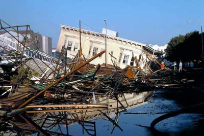 This photo shows a ground view of collapsed building and burned area at Beach and Divisadero Streets in the Marina District of San Francisco, CA, on Oct. 19, 1989. (U.S. Geological Survey/photo by C.E. Meyer)