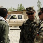 Captain Simon Pierson, Royal Signals and Officer Training Brigade Advisor confers with Afghan National Army instructors during an M-16 range at the Kabul Military Training Center near Kabul, Afghanistan, May 28, 2012.