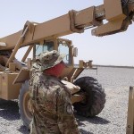 U.S. Air Force Master Sgt. Greg Pierce, a member of the Coalition Forces Sorting Facility team in Regional Support Command-South guides a forklift in Kandahar, Afghanistan, as it downloads cargo June 10 at a yard used to temporarily sort and prioritize incoming and outgoing shipments of critical repair parts for the Afghan National Army. Operation Keystone 9 started mid-summer and is expected to conclude in the fall. (U.S. Navy Photo by Lt. Cdr. Trey Scudder, RSC-South Logistics Training and Advisory Team deputy)