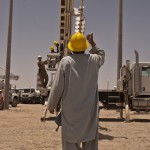 An Afghan electrical technicians practice hand signals while a fellow student learns how to operate a truck-mounted augur system used to emplace utility poles during a 10-day class led by South District NCOs June 10-19. (USCAE photo by Dave Melancon)