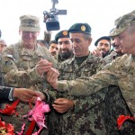 From left: Ali Daryab, Omran Holding Group quality control manager, U.S. Air Force Col. Benjamin Wham, Afghan Maj. Gen. Shazadah, and U.S. Army Maj. Gen. Kendall Cox cut a ribbon to commemorate the opening of the troop medical clinic on Camp Zafar, near Herat, Afghanistan Dec. 15. (USACE Photo by Karla K. Marshall)