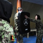 Afghan air force Lt. Nafisa Adeb performs a simulated neck strike on Air Force Capt. William Boland, a force support officer with the 439th Air Expeditionary Advisory Squadron, during a woman's self-defense class at Kabul International Airport, Feb. 29, 2012. The training was held to prepare the students physically and mentally for what they may experience if placed in a dangerous scenario. (Photo by Staff Sgt. Nadine Barclay)