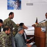 U.S. Army Capt. Owen Brown, chief of Contracting and Acquisition Advisory Team at Deputy Command of Support Operations under NATO Training Mission - Afghanistan passes out handouts for a contracting class on Sept. 12 at the Afghan National Army's Logistics Command in Kabul, Afghanistan. The contracting class was a four-day test run of a 14-day model, aiming to socialize the training material with select members of the Afghan National Security Forces and to obtain valuable feedback on the contents of the classes. (U.S. Army photo by Capt. Monika Comeaux, DCOM-SPO/NTM-A PAO)