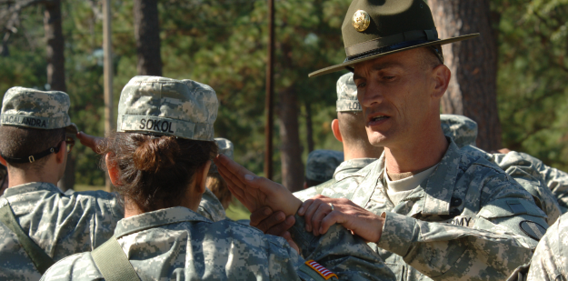 Photo of a Drill Sergeant helping a Soldier