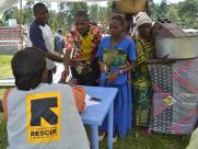 An IRC staff member checks merchandise of visitors who have cashed in coupons.