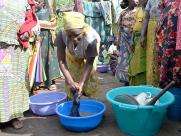 A woman with the washing basins she bought at the fair.