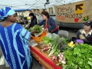 Refugees sell their produce at a local farmers market in San Diego.