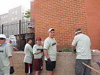 Deputy Comptroller for Community Affairs Barry Wides works on landscaping at the 2011 NeighborWorks Week event.