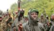 M23 rebel fighters celebrate in the rain at Rumangabo after government troops abandoned the town 23 kilometers north of the eastern Congolese city of Goma, July 28, 2012.