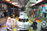 In this split screen image, Argonne engineer Henning Lohse-Busch evaluates an electric vehicle under extreme hot (left) and cold conditions (right). The Advanced Powertrain Research Facility’s Environmental Test Cell is equipped to evaluate vehicles and their components at a temperature range of 20°F to 95°F.