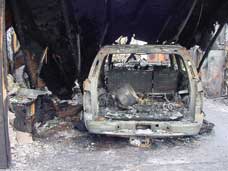 A sport utility vehicle (SUV) after an arson fire. Photo: John A. Bohn