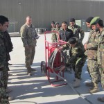 Afghan air force members receive instruction of the proper use of an aircraft fire bottle during the maintenance fundamentals course at Kandahar Airfield, Afghanistan, Jan. 26, 2012. (Courtesy Photo)