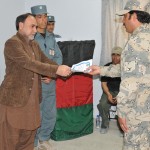 Haji Mohammad Naseem, the deputy mayor of Kandahar, gives a certificate of completion to a graduate of a basic criminal investigation course, Mar. 29, 2012, during a graduation ceremony held at the Kandahar Training Center. A total of nine Afghan Border Police and guard force members completed the three and a half week course which taught lessons in improvised explosive device awareness, intelligence gathering and witness, victim, and subject interviews and statements.