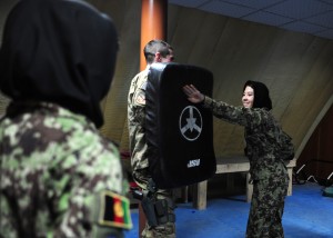 Afghan air force Lt. Nafisa Adeb performs a simulated neck strike on Air Force Capt. William Boland, a force support officer with the 439th Air Expeditionary Advisory Squadron, during a woman's self-defense class at Kabul International Airport, Feb. 29, 2012. The training was held to prepare the students physically and mentally for what they may experience if placed in a dangerous scenario. (Photo by Staff Sgt. Nadine Barclay)