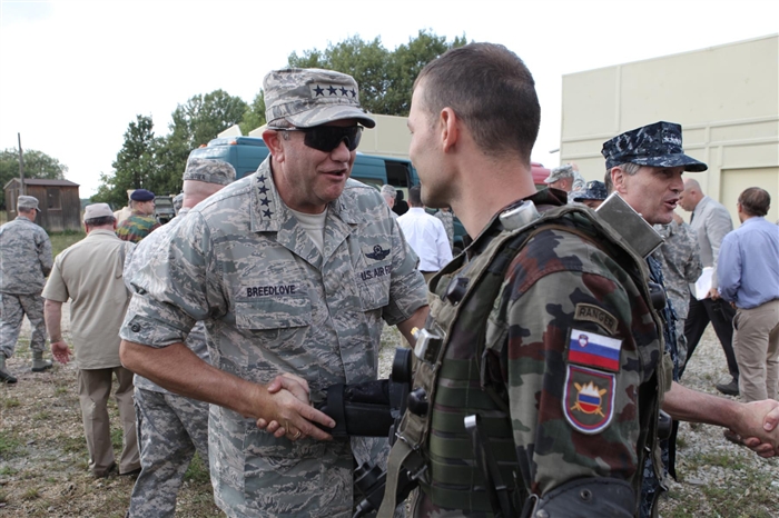 GRAFENWOEHR, Germany - Gen. Philip M. Breedlove Commander, U.S. Air Forces in Europe; Commander, U.S. Air Forces Africa, congratulates a Slovenian soldier after viewing his performance during a KFOR 16 STX Lane exercise at the Joint Multinational Readiness Center in Hohenfels, Germany. General Breedlove is a key participant of the 2012 Combatant Commander's Conference, which takes place August 22 and 23 at the Joint Multinational Training Command, or JMTC, in Grafenwoehr, Germany is hosted by the United States Army in Europe and brings Europe's combatant commanders and senior enlisted advisor's together to discuss issues, challenges and opportunities to develop interoperability and unity of effort. The JMTC is the U.S. Army's largest overseas training command and regularly provides U.S. and international Soldiers facilities and opportunities to train in a sophisticated, complex, and real-time battle environment.