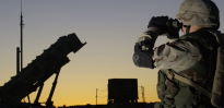 Soldier views a Patriot missile through binoculars 