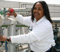 Photo of a woman holding a red rag with her other hand on a handle.