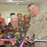 Afghan National Army Maj Gen. and Army Col. David Komar, from Deputy Commanding General-Operations, Training and Requirements, cut the ribbon during the grand opening ceremony for the newest Intense English Language Training Center (IELTC) at the National Military Academy of Afghanistan June 5. (Courtesy Photo)