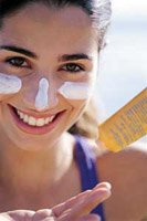 Teen girl applying sunscreen