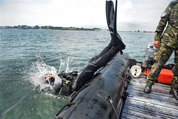 CONSTANTA, Romania (May 31, 2012) – Azerbaijani navy Explosive Ordnance Disposal Technician 1st Class Coskun Safiyeu, left, dives from a small boat during Eurasian Partnership (EP) Dive 2012. EP Dive 2012, a multinational training event co-hosted by the Romanian and U.S. Navies, includes participants from Azerbaijan, Bulgaria, Georgia, Romania, Ukraine and U.S. 