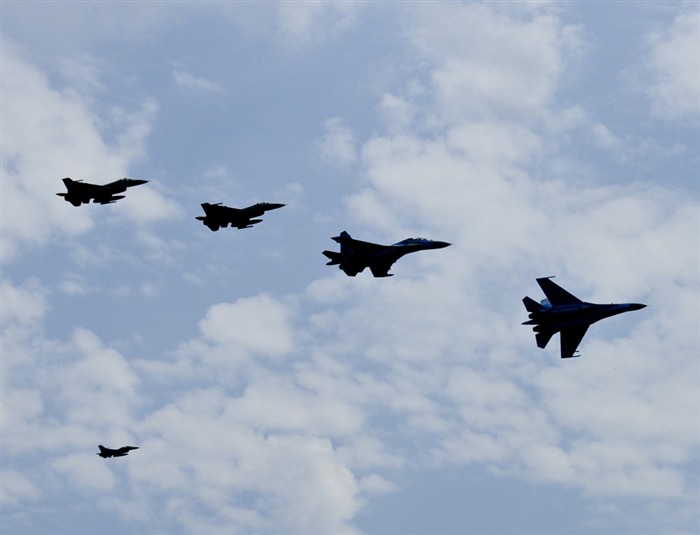 Two Air National Guard F-16s fly in formation with 2 Ukraine SU-27s over Mirgorod Air Base, Ukraine while a chase plane sits in the background.  The Air National Guard is in Ukraine supporting SAFE SKIES 2011, a 2-week multinational flying event preparing Ukraine and Poland to better protect their airspace during the 2012 EUROPCUP.   (U.S. Air Force Photo by Master Sgt.  James D. Berg, 144 FW/CF  / Released)     