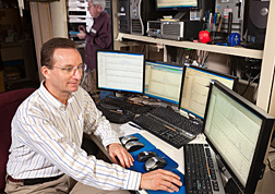 Photo: ARS chemist Craig Byrdwell studies food composition data on computer screens. Link to photo information