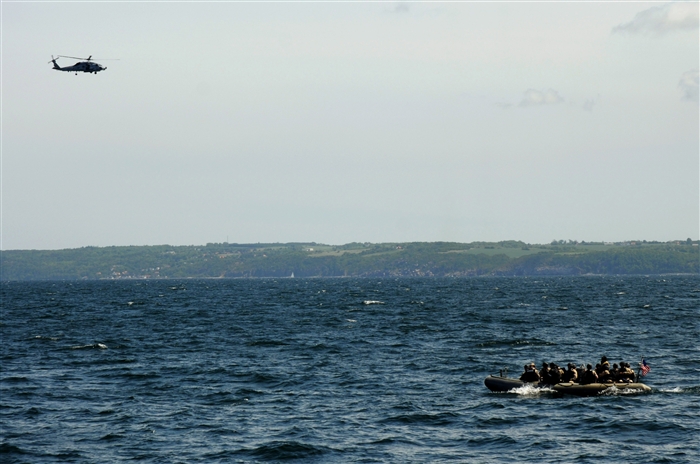 BALTIC SEA – The guided-missile cruiser USS Normandy’s (CG 60) visit, board, search and seizure team ride in a rigid hull inflatable boat, June 14, to board the German FGS Werra (A 514) for a scenario boarding exercise in conjunction with the Baltic Operations (BALTOPS) 2012 exercise. BALTOPS 2012 is one of the largest, multi-national maritime training exercises held in the Baltic region this year and is intended to improve interoperability with partner nations by conducting realistic training both on land and at sea. 