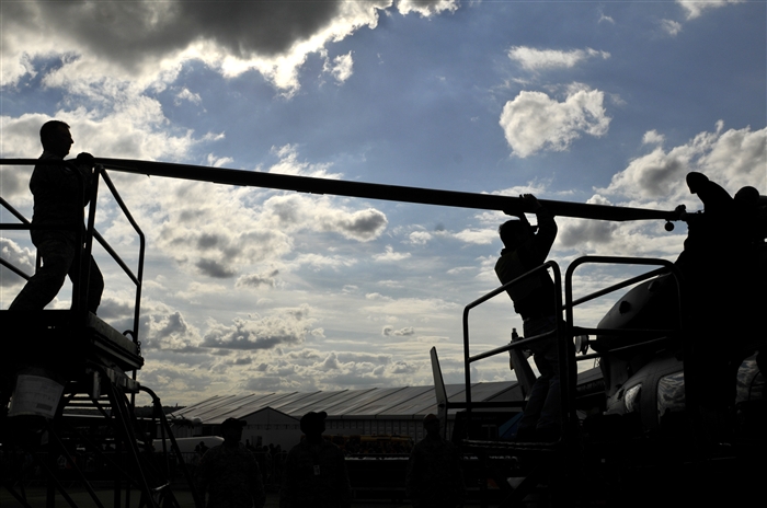 U.S. military personnel remove a propeller from an LUH-72 Lakota in preparation for shipment July 15, 2012, following the Farnborough International Air Show in Farnborough, England. Approximately 90 aircrew and support personnel from bases in Europe and the United States participated in the air show. More than 250,000 trade and public visitors attend the bi-annual event which concluded July 15.