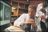 Health care professionals studying images on a computer screen