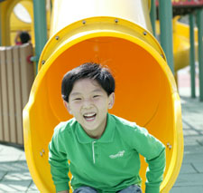 Boy Getting off Slide