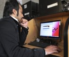 An Iranian man uses a computer in an internet cafe in central Tehran, Iran,