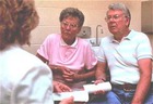 Man and woman consulting with a physician. - Click to enlarge in new window.