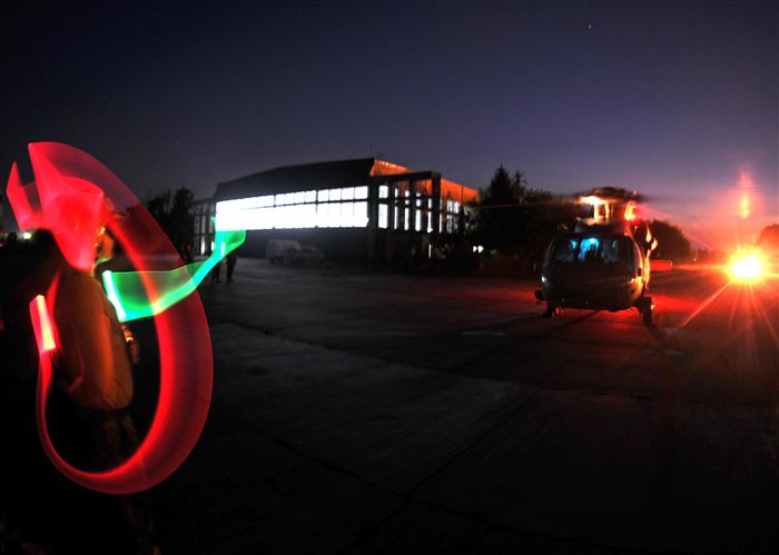 MIHAIL KOGĂLNICEANU AIRBASE, Romania—A Sailor with the Helicopter Sea Combat 28 signals to a MH-60S Seahawk helicopter prior to a night Forward Area Refueling Point training event as part of the Special Operations Command Europe’s Jackal Stone 11 exercise on Mihail Kogălniceanu Air Base, Romania, Sept. 16, 2011. The Seahawk landed in a field and was refueled by a MC-130H Combat Talon II, based out of 352nd Special Operations Group at RAF Mildenhall, U.K. The purpose of the exercise is to enhance special operations forces capacity and interoperability between the nine participating nations, while simultaneously building cooperation and partnerships. 