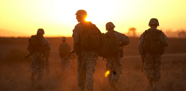 Army ROTC cadets walking across field