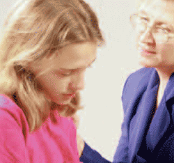 Photo of a woman talking with a younger girl.