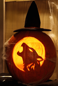 Elaborately carved halloween pumpkin of a howling dog