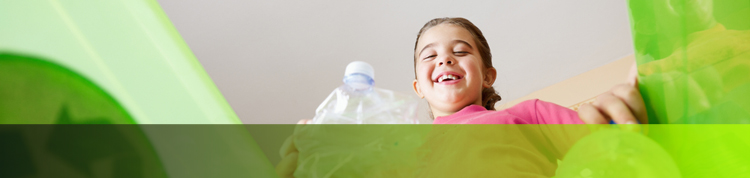 photo of girl throwing bottle in recycle bin