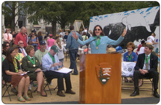 Michael Breis sings the Star-Spangled Banner at Yellowstone 90th Anniversary Celebration. Standing from left to right are Secretary Kempthorne, Director Mainella, Senator Thomas, and Superintendent Lewis.