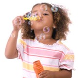 Little girl blowing bubbles